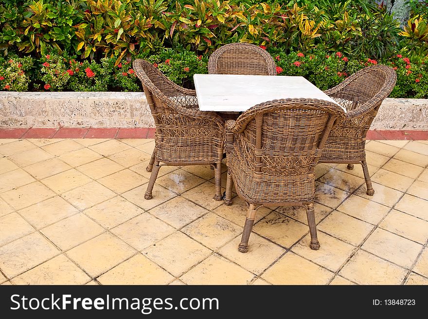 Brown wooden chairs an tables on patio