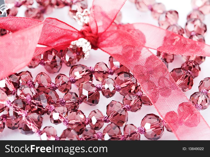 Pink beads on white background
