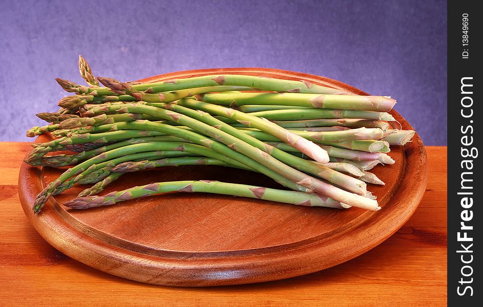 Some asparagus on wooden board