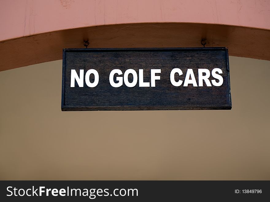 Black and white sign at a golf club displaying no golf cars. Black and white sign at a golf club displaying no golf cars.