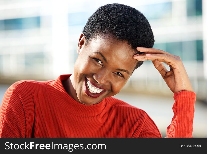 Close up portrait of beautiful young african woman smiling outside. Close up portrait of beautiful young african woman smiling outside