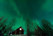The Northern Lights Aurora Borealis At Kuukiuru Village Lake In Lapland, Finland Royalty Free Stock Images
