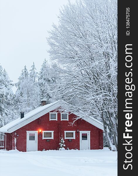 The house in the forest has covered with heavy snow and bad sky in winter season at Holiday Village Kuukiuru, Finland