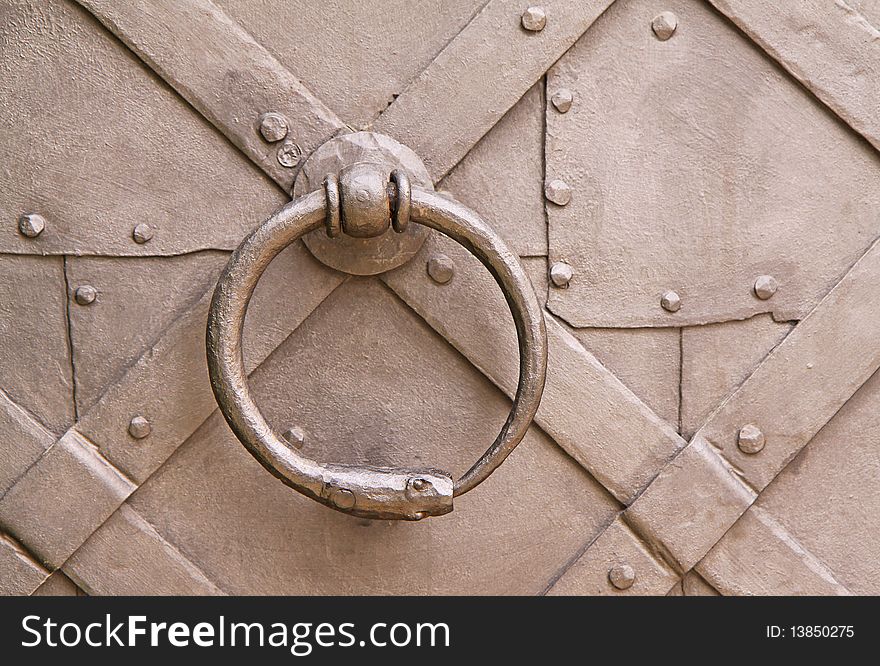 Steel knocker on the old rustic historic door