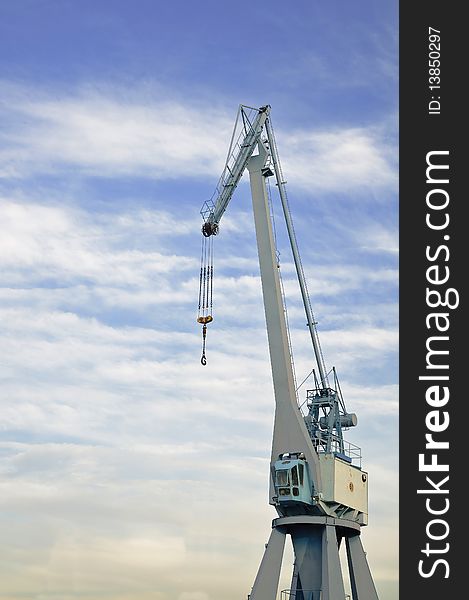 Port crane with blue sky and come clouds