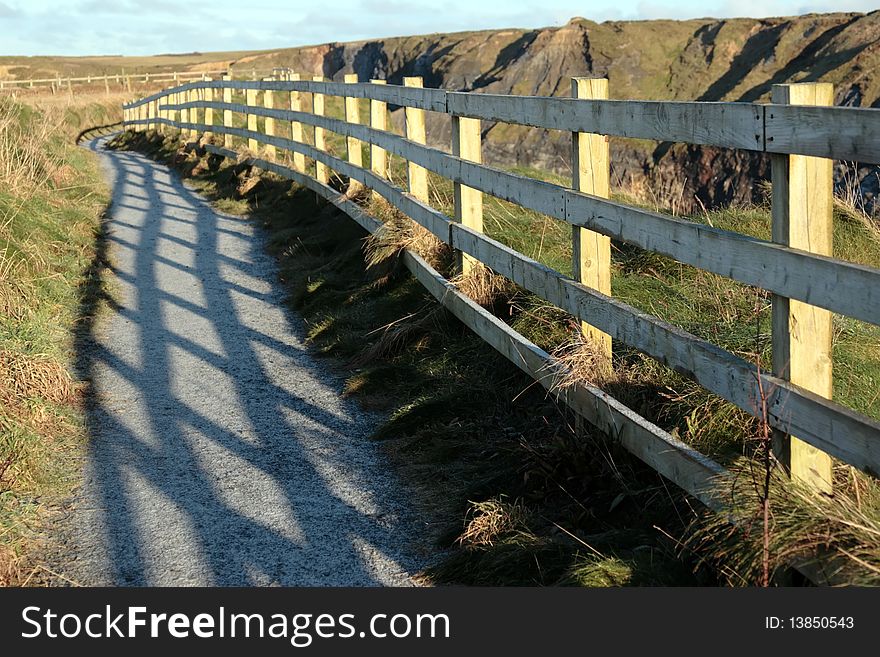 Frosty winters view at ballybunion cliffside walk with atlantic view and fence shadows. Frosty winters view at ballybunion cliffside walk with atlantic view and fence shadows