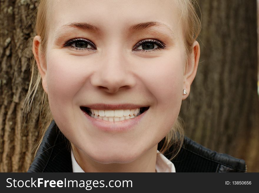 Portait of young beautiful smiling woman, outdoor shot