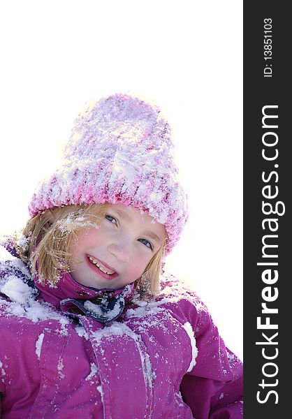 Portrait of young little girl playing in the snow with focus on eyes. Portrait of young little girl playing in the snow with focus on eyes