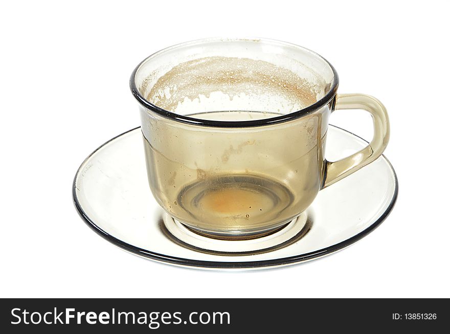 Dirty transparent coffee cup on saucer on white background. Dirty transparent coffee cup on saucer on white background
