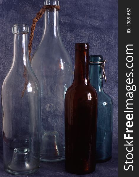 Empty bottles isolated on painted background