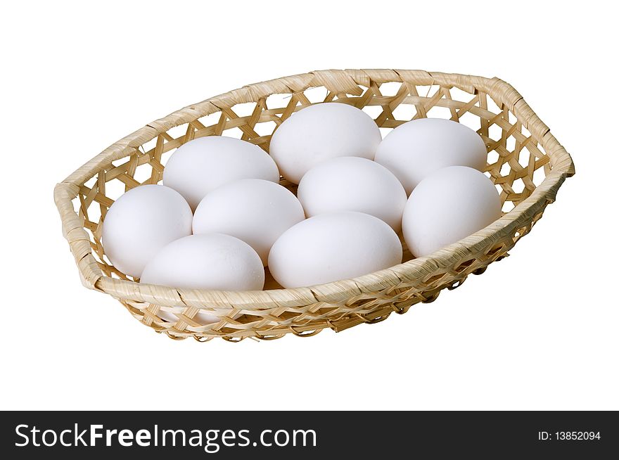 Nine eggs in basket isolated on white. Nine eggs in basket isolated on white