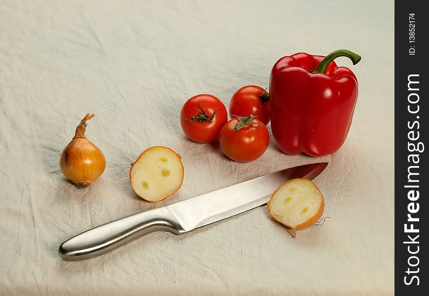 Vegetables and large knife on light background. Vegetables and large knife on light background