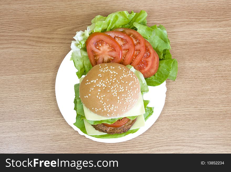 Delicious beaf burger with cheese, lettuce, tomato and mayo. Delicious beaf burger with cheese, lettuce, tomato and mayo
