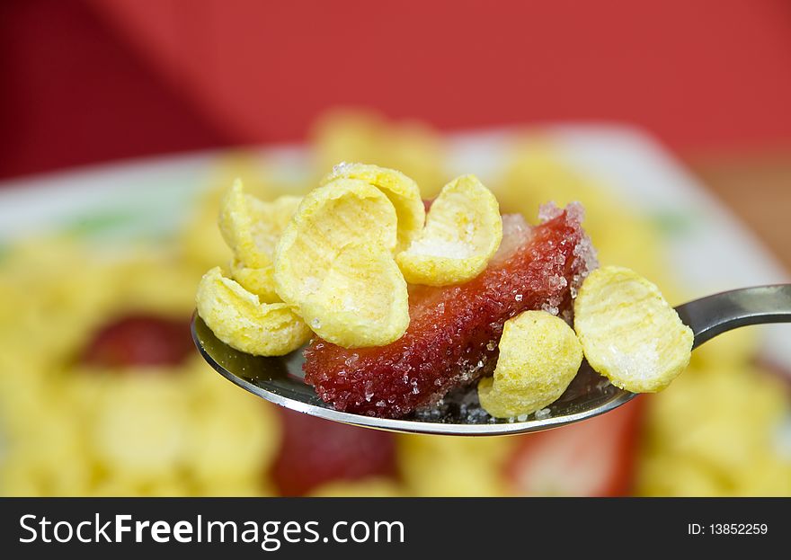 Macro on a spoon full of cereals with strawberries. Macro on a spoon full of cereals with strawberries