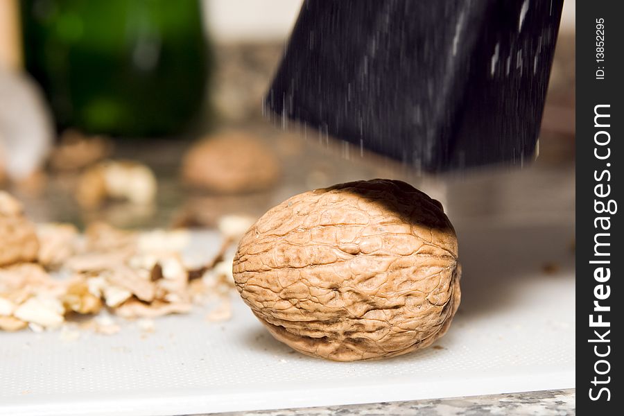 Walnut ready to be crushed by a hammer. Walnut ready to be crushed by a hammer