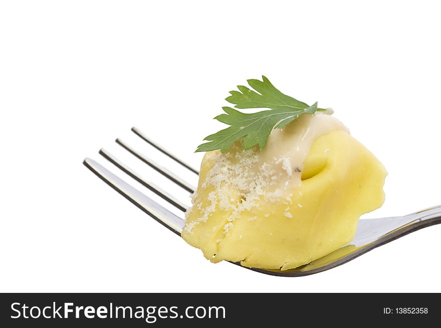 Macro on a tortellini with white sauce, isolated on white