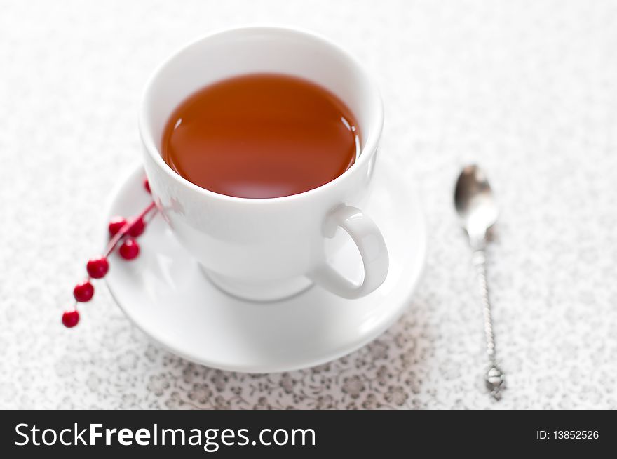Cup of tea with berries background
