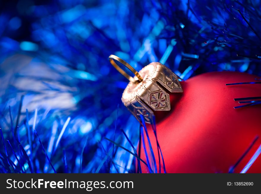 Beautiful red bauble on blue christmas decoration