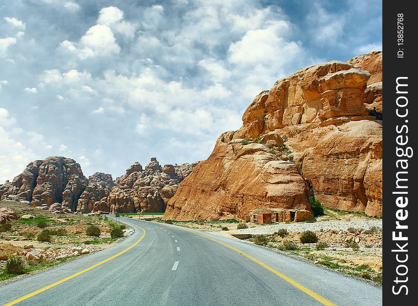 Asphalt road blue sky with clouds and mountains