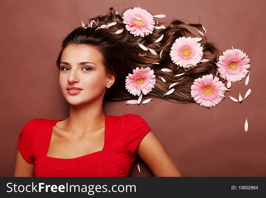 Young beautiful woman with pink fresh flower. Young beautiful woman with pink fresh flower