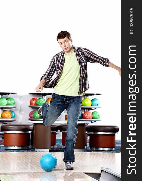 The young man kicks a sphere for bowling