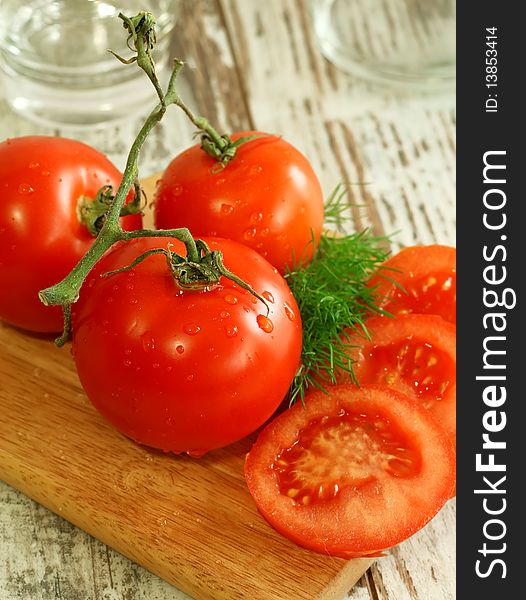 Fresh Tomatoes With Water Drops On Wooden