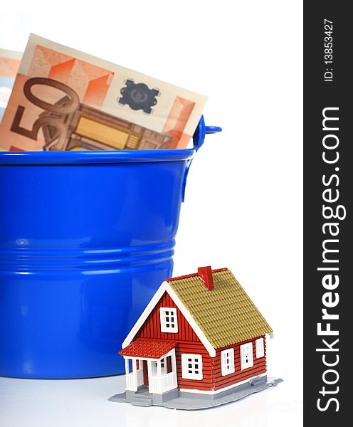 House, european money inside the bucket isolated over white. House, european money inside the bucket isolated over white.