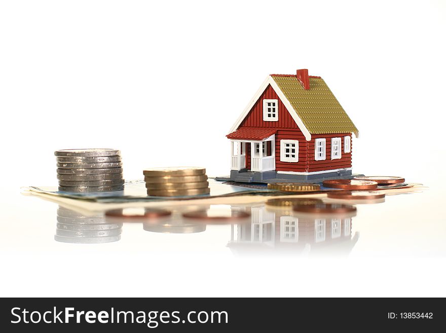 Little house and european money isolated over white. Little house and european money isolated over white.