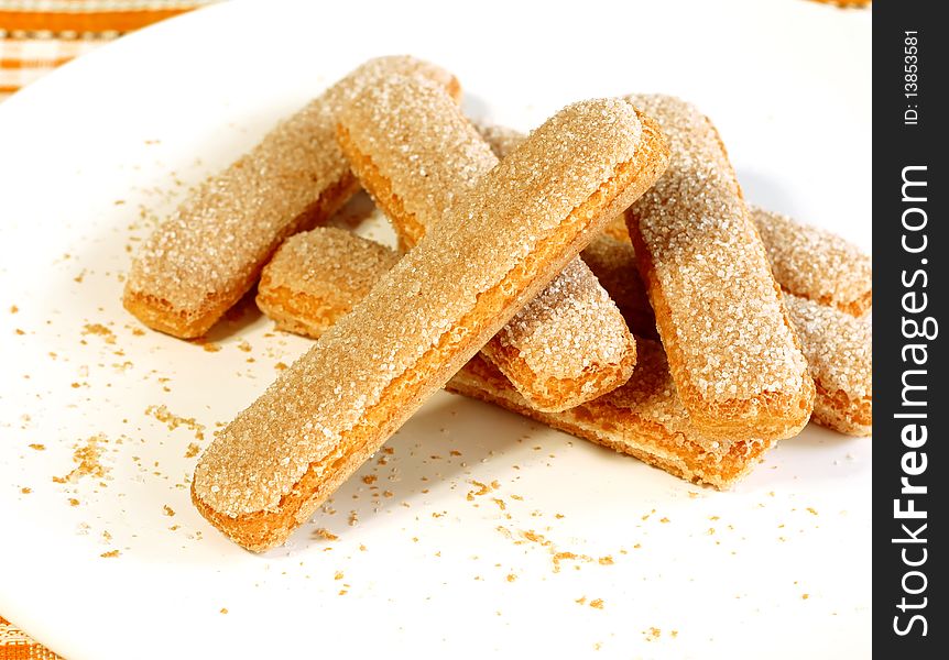 Cookies strewed by sugar on white plate