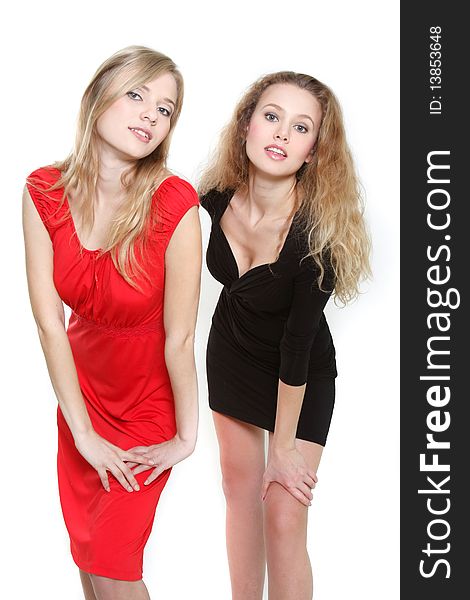 Two attractive girls in red and black dresses over white. Two attractive girls in red and black dresses over white