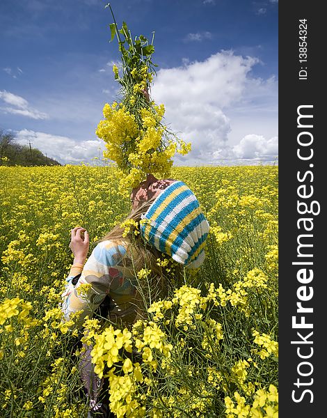 The girl on a background of yellow flowers. The girl on a background of yellow flowers