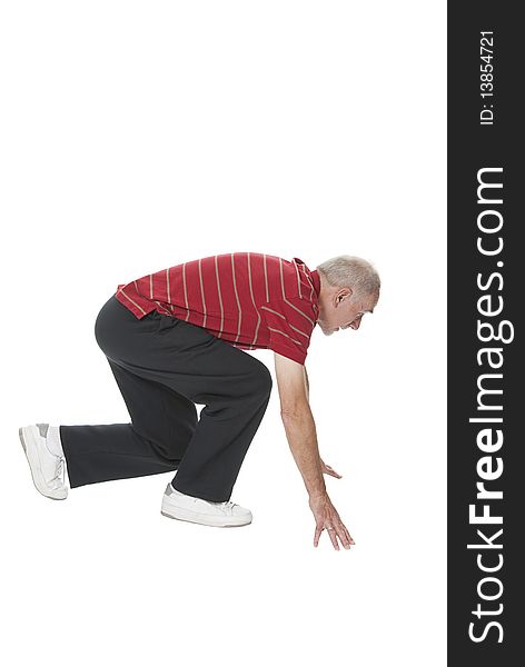 Old man in sportswear in ready position for starting a sprint. Active and fit senior isolated on white. Old man in sportswear in ready position for starting a sprint. Active and fit senior isolated on white.