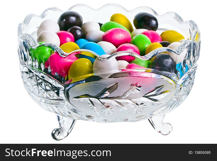 Vase with colour sweets on a white background