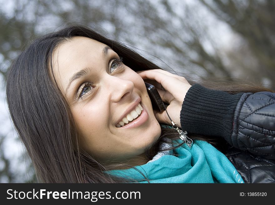 Young beautiful woman on the phone in the park. Young beautiful woman on the phone in the park
