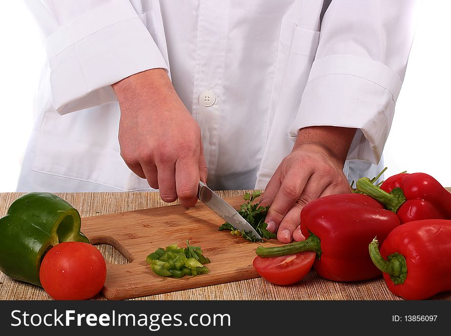 The cook on a kitchen board cuts parsley.