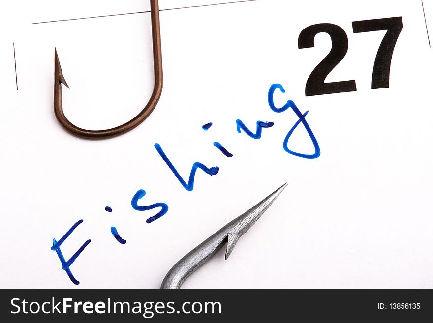 Day of fishing, is noted in a calendar. In a shot text Fishing and fishing hooks.