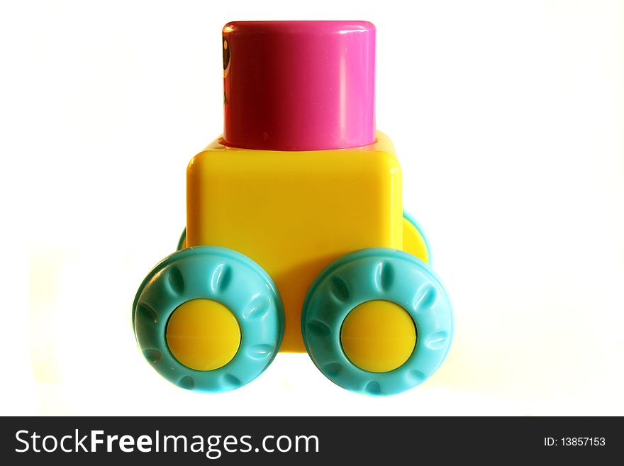 Toy block on wheels, isolated on white