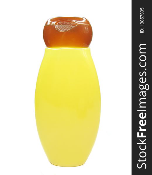 Bright yellow shampoo bottle isolated on white background