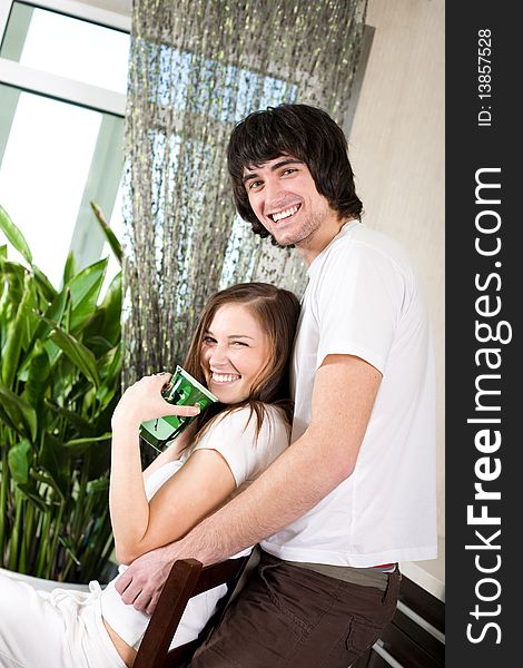 Girl with green cup and boy with smile