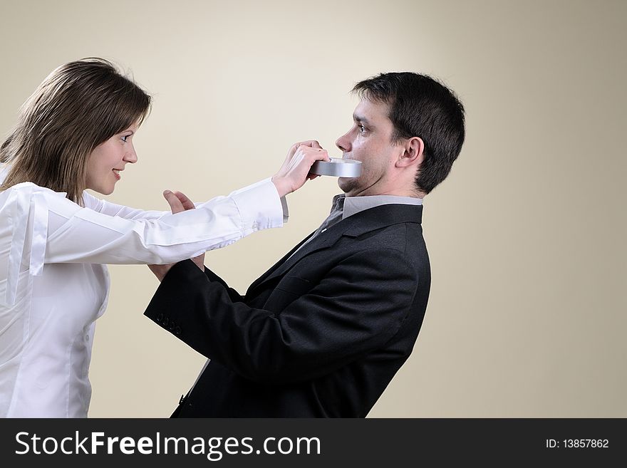 White business woman gluing his partner mouth in office. White business woman gluing his partner mouth in office