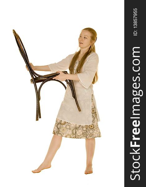 Young woman holding a chair on a white background