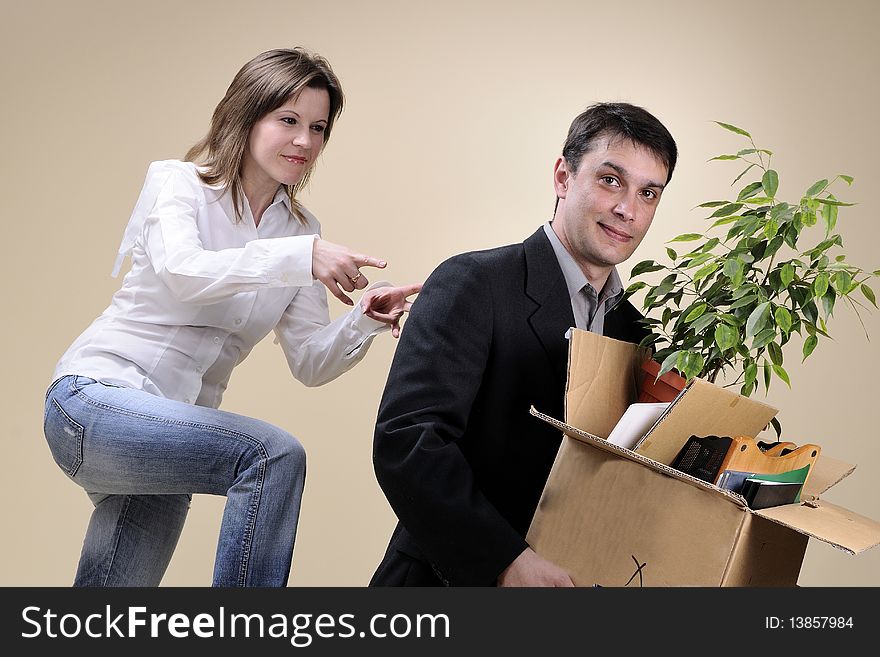 Upset fired man holding box with pland and documents and his boss firing him. Upset fired man holding box with pland and documents and his boss firing him