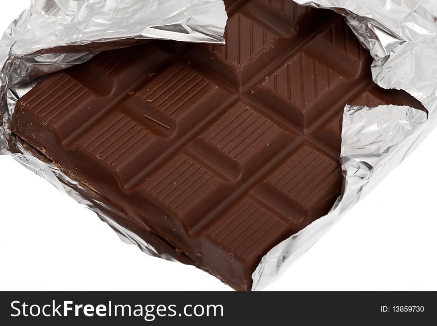 Chocolate with foil, sweet isolated against white background