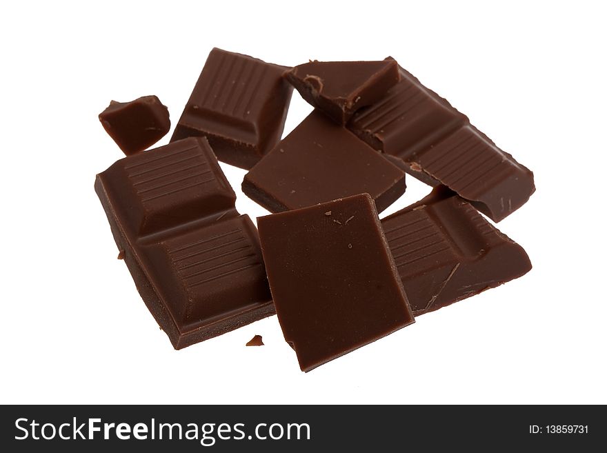 Chocolate broken in pieces, sweet against white background