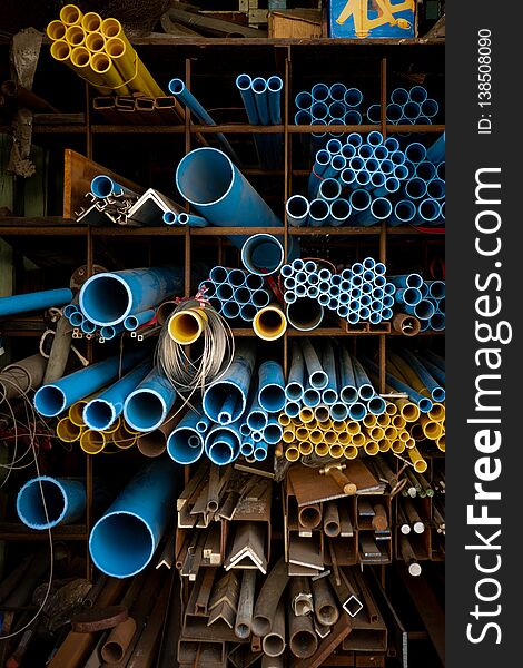 Blue and yellow PVC pipes in warehouse