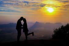 Silhouette Happy Young Couple In Love Looking View Sunset On The Mountain. Romantic Couple In Love Royalty Free Stock Photo