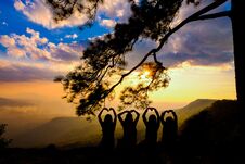 Silhouette Happy Young Couple In Love Looking View Sunset On The Mountain. Romantic Couple In Love Stock Image