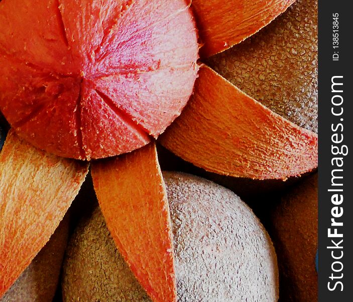 Delicious and beautiful mamey, the skin is brown, oval, there is one open and looks like a flower with the shell like petals and in the center the fruit of the mamey, is on top of other mameys