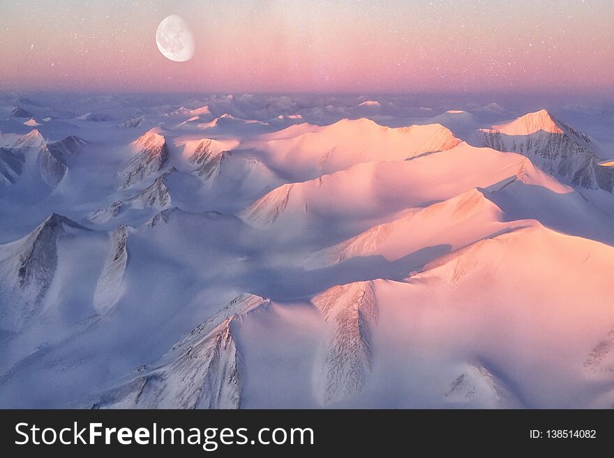 Ellesmere Island mountain tops bathed in light as the sun began to peak over the horizon. Elements of this image furnished by NASA