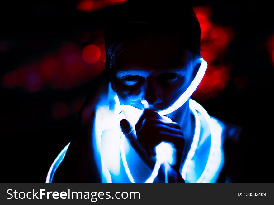 Portrait man Strip Light LED tape on dark color background.